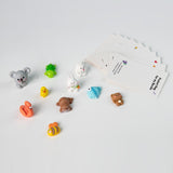 Collection of small toys and greeting cards on a white background