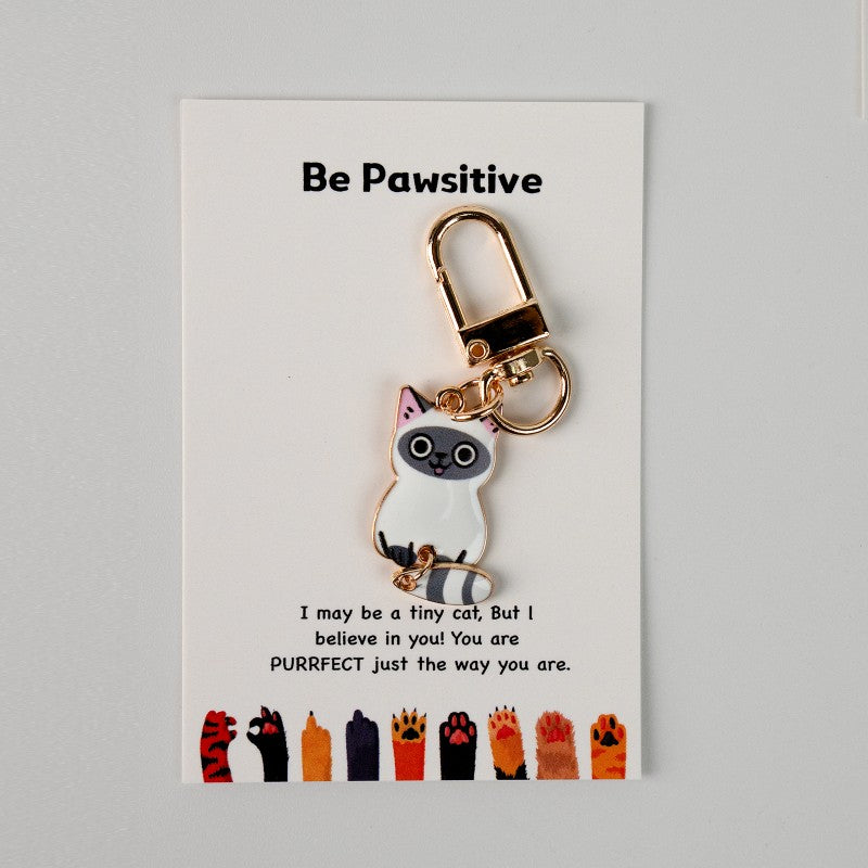 Cat keychain with motivational message on a card