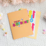 Happy Birthday card with colorful text on a textured surface with decorative elements.