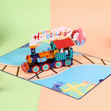 3D paper train with a 'Happy Birthday' sign on a colorful background