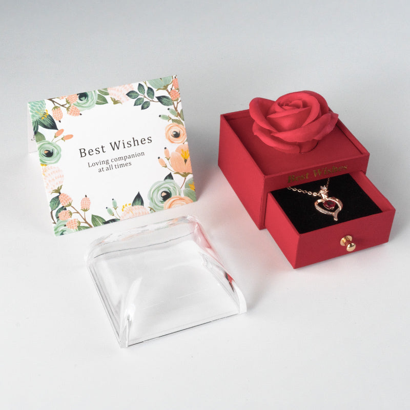 Red gift box with necklace and card on white background