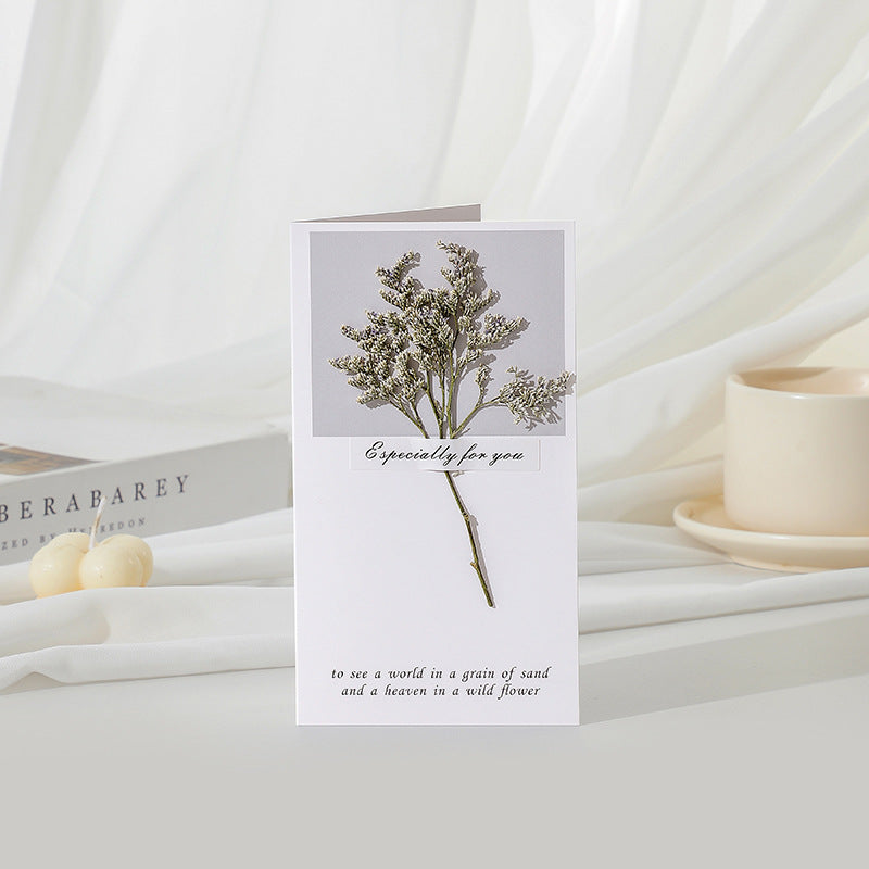 Greeting card with floral design and text on a white surface