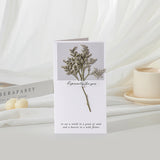 Greeting card with floral design and text on a white surface