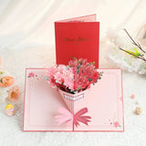 Greeting card with a 3D bouquet of pink flowers and a red envelope labeled 'Best wishes' on a light background.