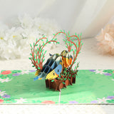 3D paper craft of fish and trees on a green background with flowers.