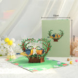 3D pop-up card with birds and trees on a white surface with measurements shown.