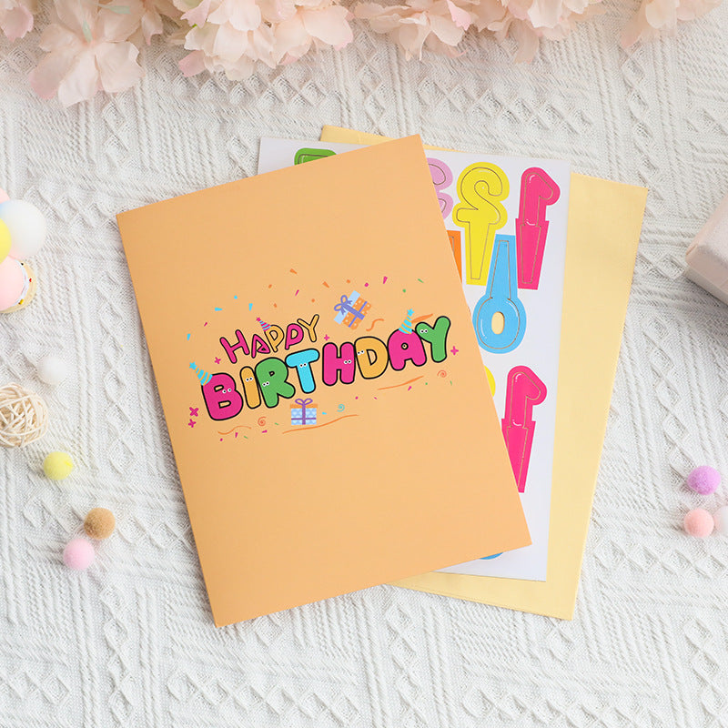 Happy Birthday card with colorful text on a textured surface with decorative elements.