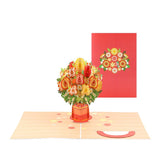 A 3D pop-up greeting card featuring a bouquet of sunflowers in a red vase with a matching red envelope.