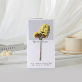 Greeting card with yellow flowers and text on a white surface