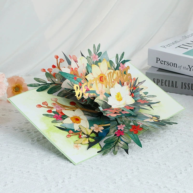 Pop-up card with floral design and 'Happy Birthday' text on a textured surface.