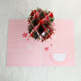 Pink card with floral design on a textured white background