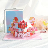 Pop-up card with heart designs and 'LOVE' text, displayed on a white surface with measurements shown.
