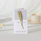 Greeting card with wheat design on a white surface