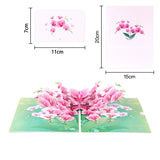 Pop-up card with pink flowers and measurements on a white background