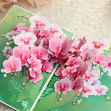 Pink orchid flowers on a green card with floral design