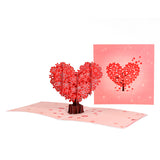 A 3D pop-up greeting card featuring a cherry blossom tree in the shape of a heart, with red petals and a premium envelope.