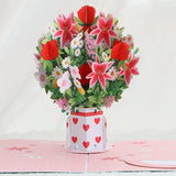 3D pop-up card with a bouquet of flowers and a heart-patterned vase on a white background.